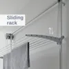 A wall-mounted drying rack with towels hanging on it. Anteprima dell’immagine prodotto