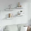 Four white marble-effect shelves mounted on a light gray wall, with decorative items on them. Produktbild-Vorschau