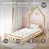 A child's wooden cot with a house-shaped headboard, set in a bedroom with pink walls and white curtains. Náhled obrázku produktu