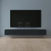 A modern living room with a wall-mounted television and a floating media console.