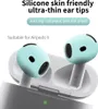 Close-up of light blue silicone ear tips for AirPods 4 placed inside a white charging case. Voir les images du produit