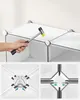 A person is assembling a modular storage unit, using a rubber mallet to tap a connector into place. Close-up views of the connectors show how they work. Náhled obrázku produktu