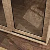 A close-up view of the bottom section of a wooden dog crate with a mesh front. Produktbild-Vorschau