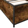 A close-up view of the corner of a bed frame with a rustic wood-like finish and black metal accents. Produktbild-Vorschau