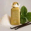 A perfume bottle is displayed with ingredients like sugar, mint, and vanilla beans. Podgląd zdjęcia produktu