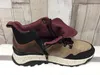 A side view of a women's hiking boot with a burgundy lining folded down. Produktbild-Vorschau