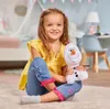 A young girl sitting on the floor holding a stuffed Olaf toy. Podgląd zdjęcia produktu