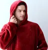A man wearing a red hoodie blanket. Produktbild-Vorschau