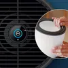 Close-up of an air purifier filter being held by hands, with a portion of the air purifier visible. Produktbild-Vorschau