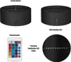 A collage of images showing different views and features of a black LED lamp base, a remote control, and close-ups of its components. Produktbild-Vorschau