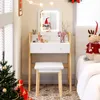 A vanity table set with a stool, decorated for Christmas with a tree, gifts, and festive ornaments. Produktbild-Vorschau