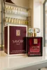A perfume bottle and its box are displayed on a reflective surface, with shelves of other perfume bottles in the background. Produktbild-Vorschau