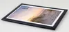 A framed picture of a beach scene with a bird flying overhead, placed on a light-colored surface. Produktbild-Vorschau