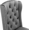 A close-up view of the tufted back and armrest of a gray velvet chair. Produktbild-Vorschau