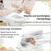 A person's hands are shown on a white marble-patterned manicure table with a built-in nail dust collector. Text overlays describe features. Voir les images du produit
