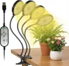 A clip-on LED grow light illuminating two potted plants on a wooden desk. Anteprima dell’immagine prodotto