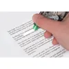 A hand is using a correction tape dispenser to cover text on a piece of paper. Produktbild-Vorschau