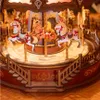 A close-up view of a wooden carousel model with horses. Produktbild-Vorschau
