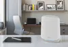 A modern home office setup with a Netgear Orbi router on a desk. Náhled obrázku produktu