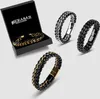 A collection of men's leather and metal braided bracelets, one in a presentation box. Anteprima dell’immagine prodotto