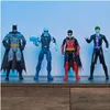 Four DC Comics action figures are displayed on a wooden shelf against a light blue background. Produktbild-Vorschau