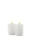 Two white LED candles with flickering flames are shown against a white background. Produktbild-Vorschau