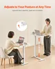 Two people using adjustable height desks in a home or office setting. Produktbild-Vorschau