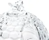 A close-up shot of the lid of a glass jar with a honeycomb pattern and a glass bee on top. Náhľad obrázku produktu
