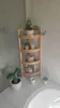 A wooden corner shelf unit with plants and bathroom accessories in a bathroom setting. Podgląd zdjęcia produktu