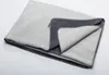 A folded blanket with a dark gray border is shown against a white background. Produktbild-Vorschau