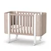 A baby crib with a mattress and pillow, shown on a white background. Produktbild-Vorschau