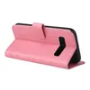 A pink flip phone case with floral and butterfly embossed details, shown open with a phone inside. Produktbild-Vorschau
