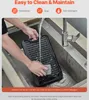 A person is washing a cast iron grill pan in a sink. Náhľad obrázku produktu