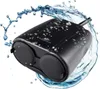 A black outdoor smart plug with water splashing around it. Náhled obrázku produktu