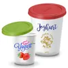 Two yogurt containers, one with a green lid and one with a red lid, are shown against a white background. The larger container has text and an illustration of a cow. Náhľad obrázku produktu