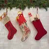 Three Christmas stockings filled with gifts hanging from a garland. Náhled obrázku produktu