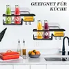 Two wall-mounted storage baskets, one above the other, holding bottles of juice and sponges. The baskets are black metal and appear to be in a kitchen setting, with a sink and countertop visible below. Produktbild-Vorschau