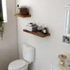 A bathroom scene with a toilet and shelves. Voir les images du produit
