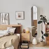A bedroom scene with a bed, nightstand, mirror, and plant. Produktbild-Vorschau