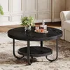 A round, black coffee table with a lower shelf, decorated with a vase of flowers and a decanter with two glasses. Produktbild-Vorschau