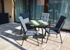 A patio set with a table and four chairs on a tiled patio. Náhled obrázku produktu