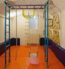 An indoor gym setup with various climbing and gymnastic equipment. Voir les images du produit