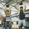 A man and a woman are performing a workout with medicine balls in a gym. Náhľad obrázku produktu