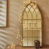 A string of LED lights resembling branches is draped over a decorative arched mirror, with a small lantern on the surface below. Produktbild-Vorschau