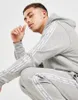 A man wearing a grey Nike tracksuit. Produktbild-Vorschau