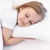 A young girl sleeping peacefully on a white pillow. Produktbild-Vorschau
