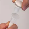 Hands holding parts of a baby bath drain hose assembly. Produktbild-Vorschau