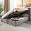 A bed with its storage compartment open, revealing stored items. Náhľad obrázku produktu