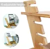 A close-up of a wooden standing desk with two inset circular images showing the desk in use. Produktbild-Vorschau