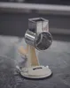 A close-up shot of a hand-cranked grater on a textured surface. Produktbild-Vorschau